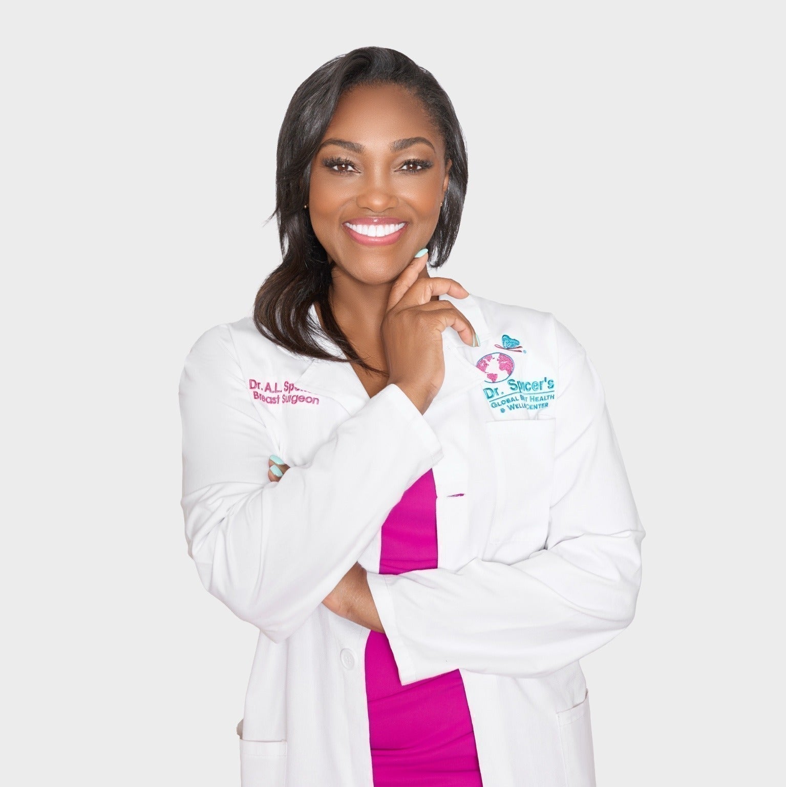 Dr. April Spencer in her white lab jacket and a pink dress