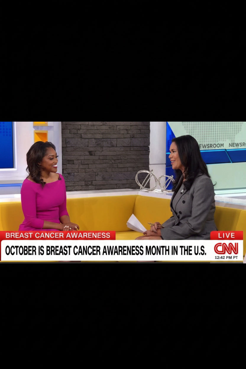 A CNN news studio interview with Dr. Spencer seated on a yellow couch, with a lower-third banner reading 'Breast Cancer Awareness' and 'October is Breast Cancer Awareness Month in the U.S.